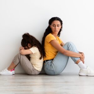 Worried Mom Looking At Offended Little Daughter After Family Argument